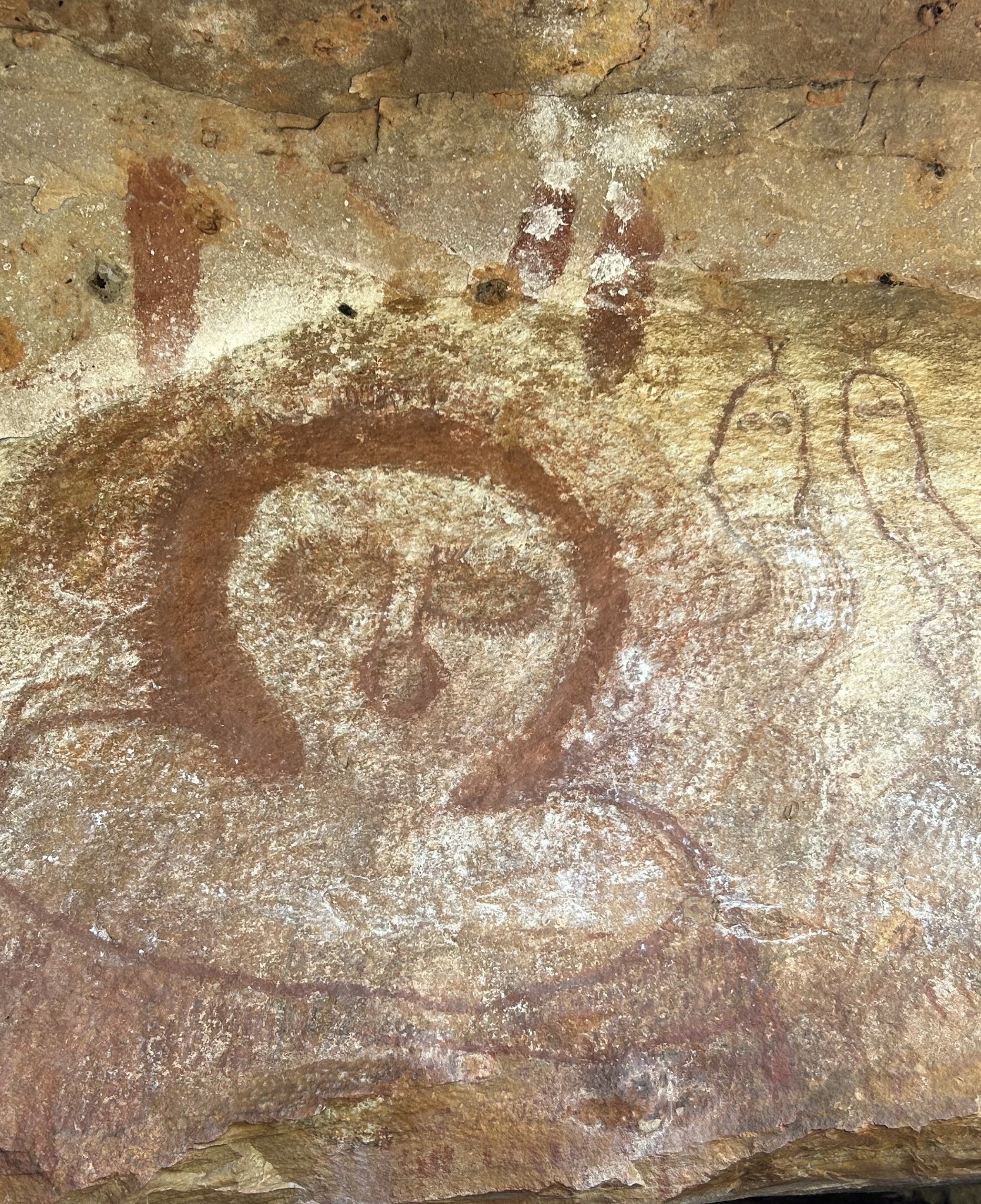 Rock art painted on a naturally weathered stone surface